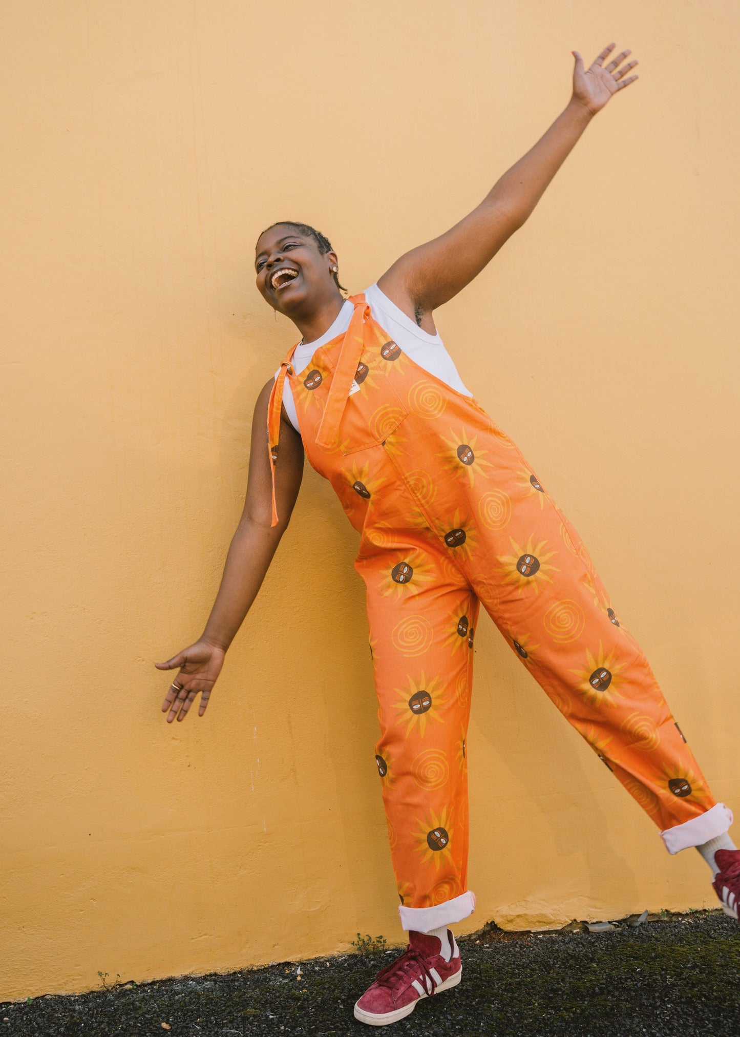 Girl wearing Orange sunflower dungaree/overall/ romper