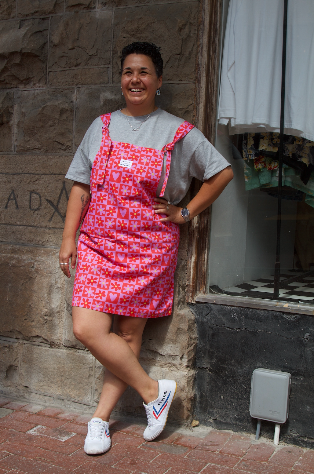 Love is the Honey dress dungaree. Pink and Red checkered pattern with flowers. Model wearing size: XL