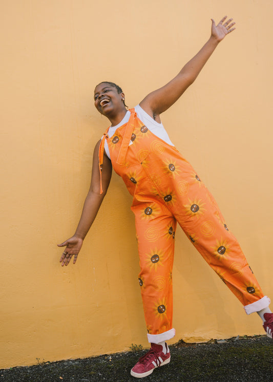 Girl wearing Orange sunflower dungaree/overall/ romper
